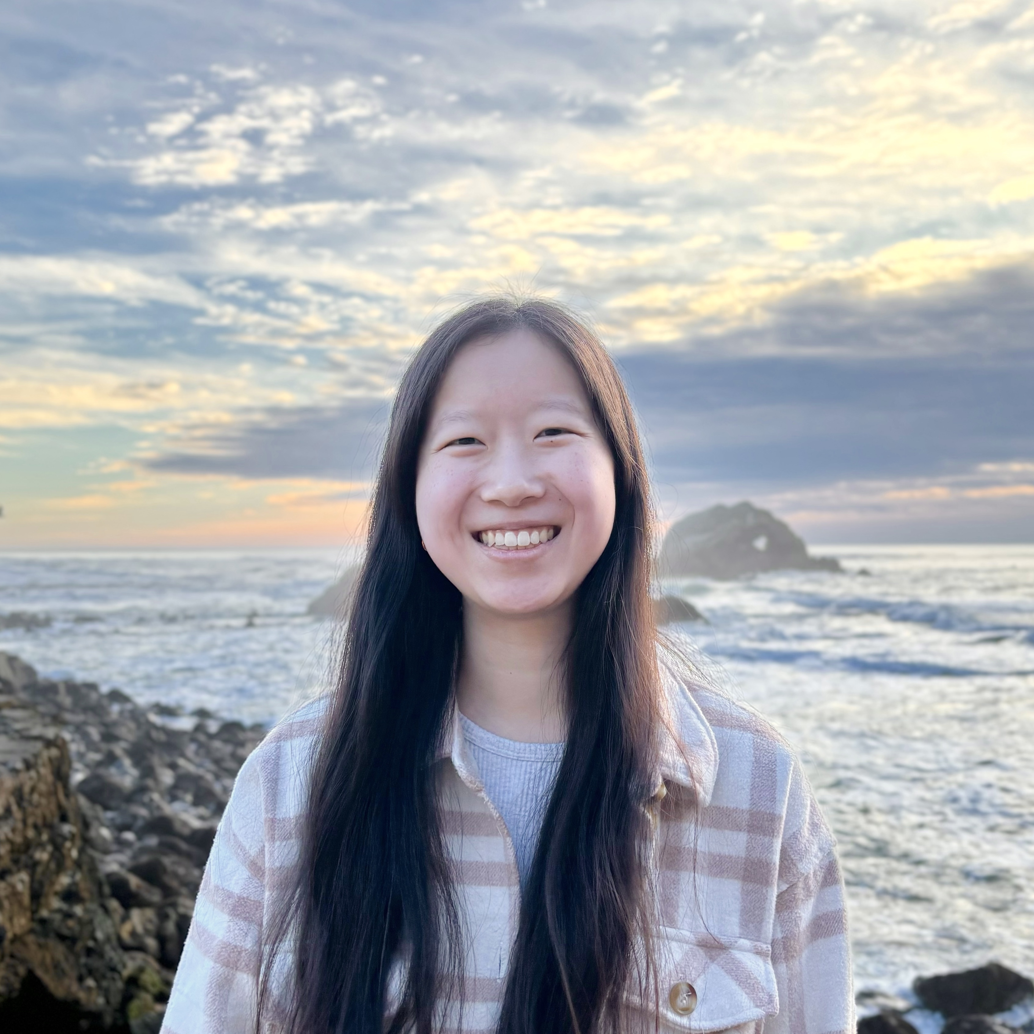headshot of Emily Tao at the beach